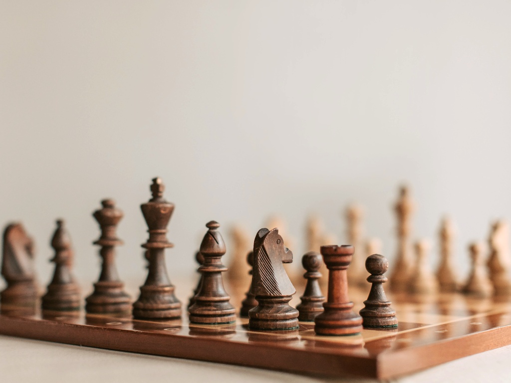 A chess board with wooden figures, illustrating the topic strategic board succession planning is crucial